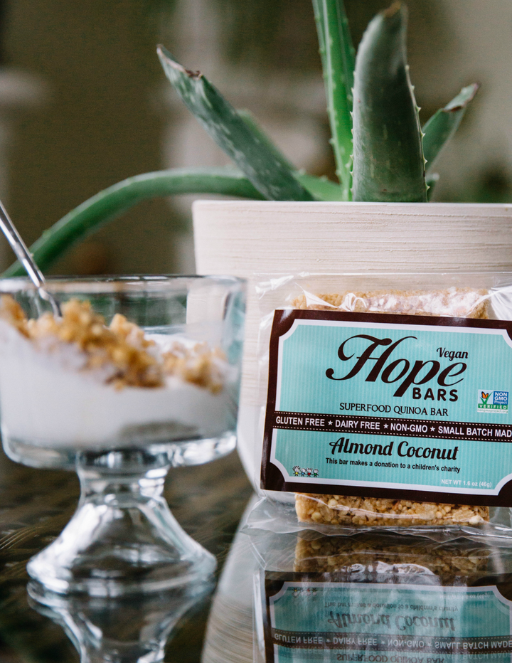 Almond coconut Hope Bar next to bowl of yogurt