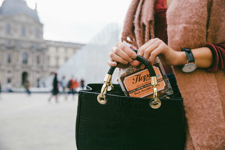 Dark Chocolate Cherry quinoa Hope bar in a purse