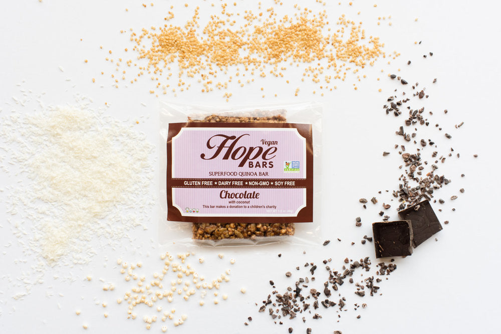 picture Chocolate Coconut Quinoa Hope bar with chocolate, coconut, and quinoa in background