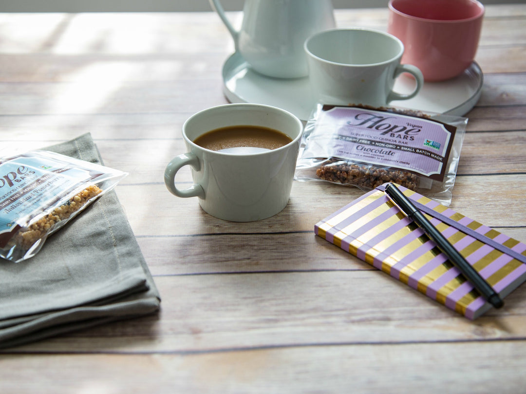 picture of Chocolate Coconut Quinoa Hope bar next to coffee cup and chocolate bar