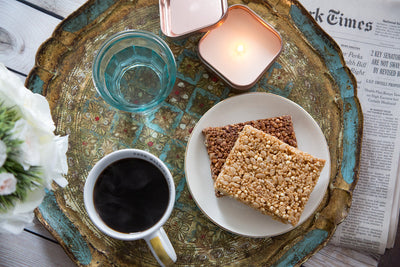 picture of Chocolate Coconut Quinoa Hope bar on a tray with coffee cup and glass of water